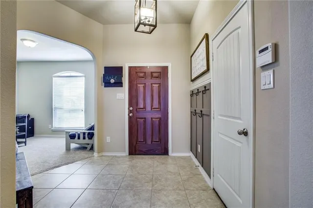 a view of hall way with furniture and windows