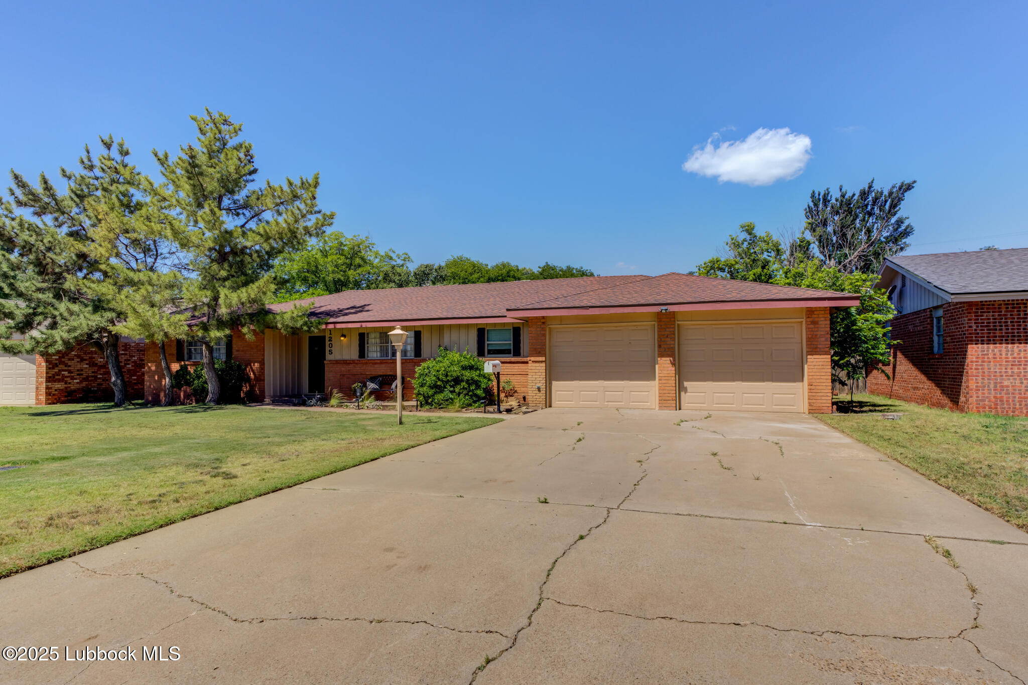 1205 Garland Plainview, TX 79072 - Photo 1 of 50 a front view of a house with a yard and a garage