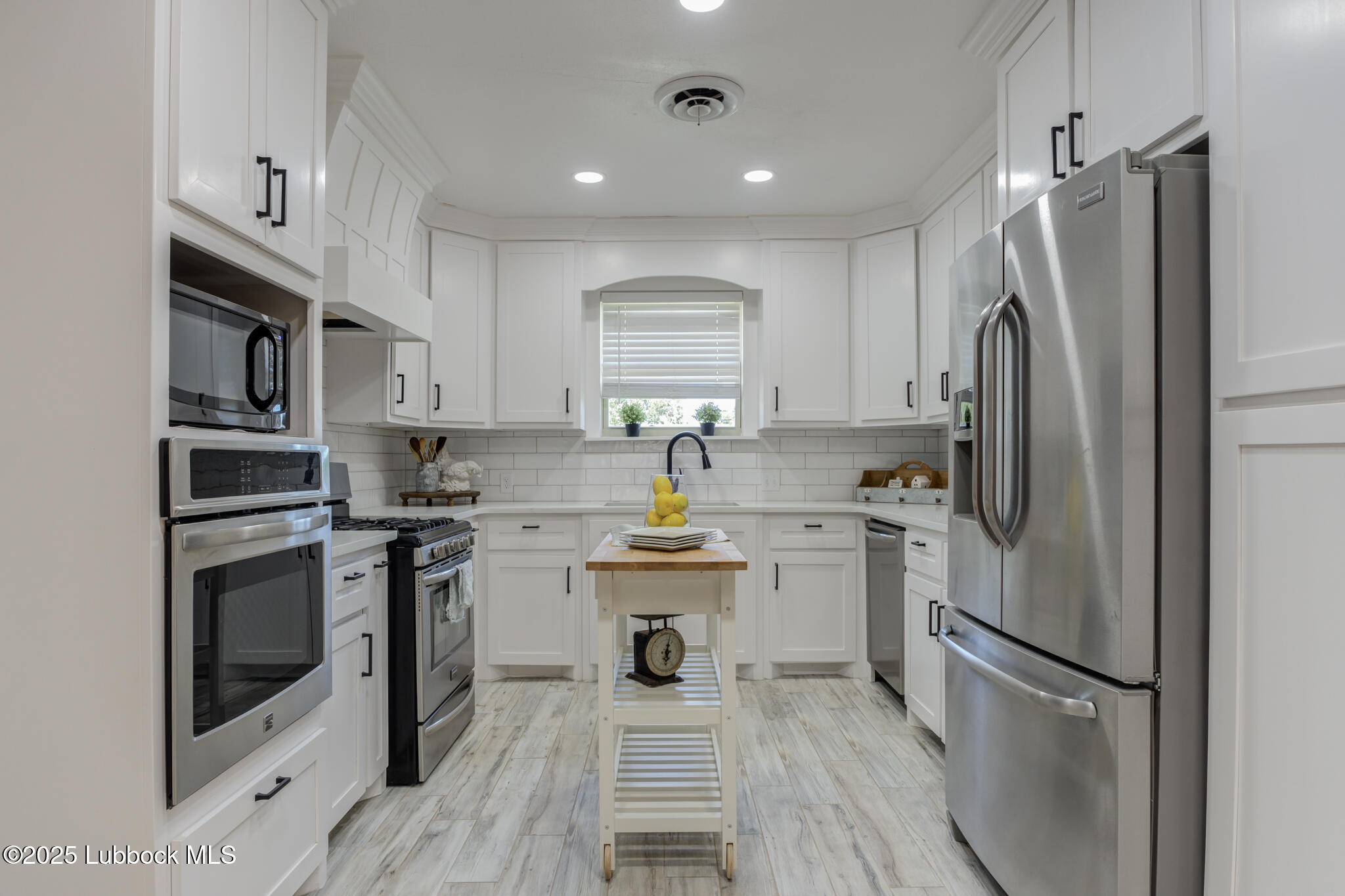 1205 Garland Plainview, TX 79072 - Photo 20 of 50 a kitchen with stainless steel appliances a refrigerator sink and white cabinets
