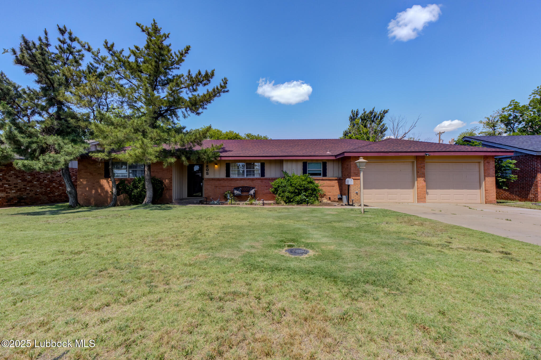 1205 Garland Plainview, TX 79072 - Photo 2 of 50 a front view of a house with a garden and yard