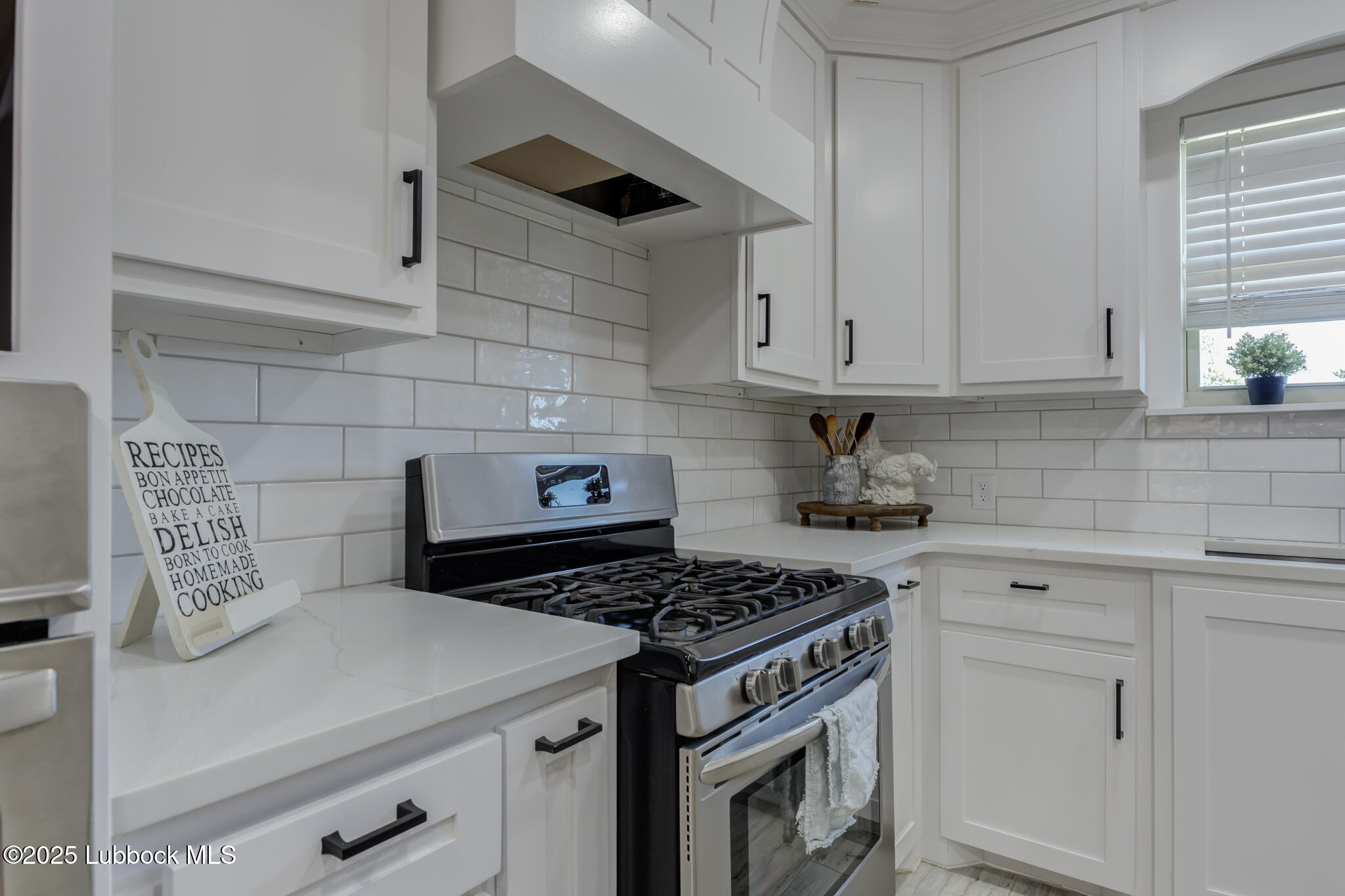 1205 Garland Plainview, TX 79072 - Photo 22 of 50 a kitchen with granite countertop a stove sink and cabinets