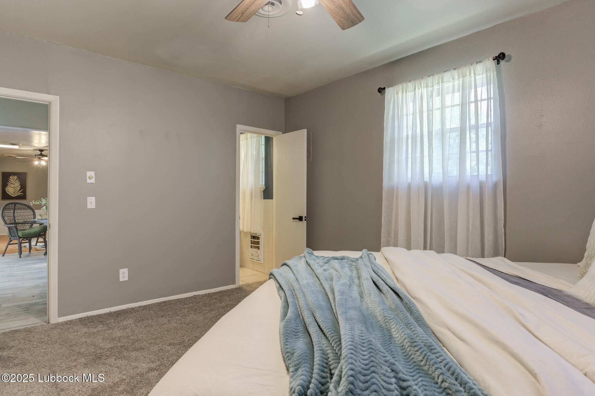 1205 Garland Plainview, TX 79072 - Photo 26 of 50 a bedroom with a large bed and a chandelier