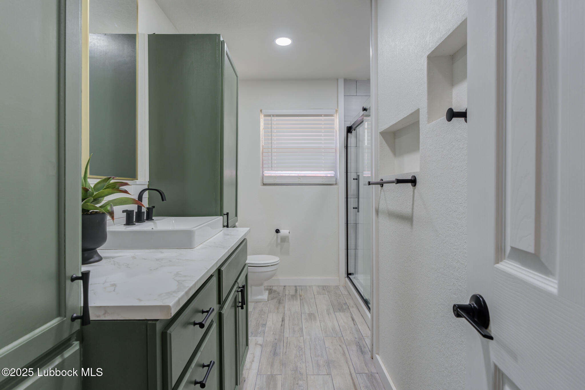 1205 Garland Plainview, TX 79072 - Photo 31 of 50 a bathroom with a sink and a mirror