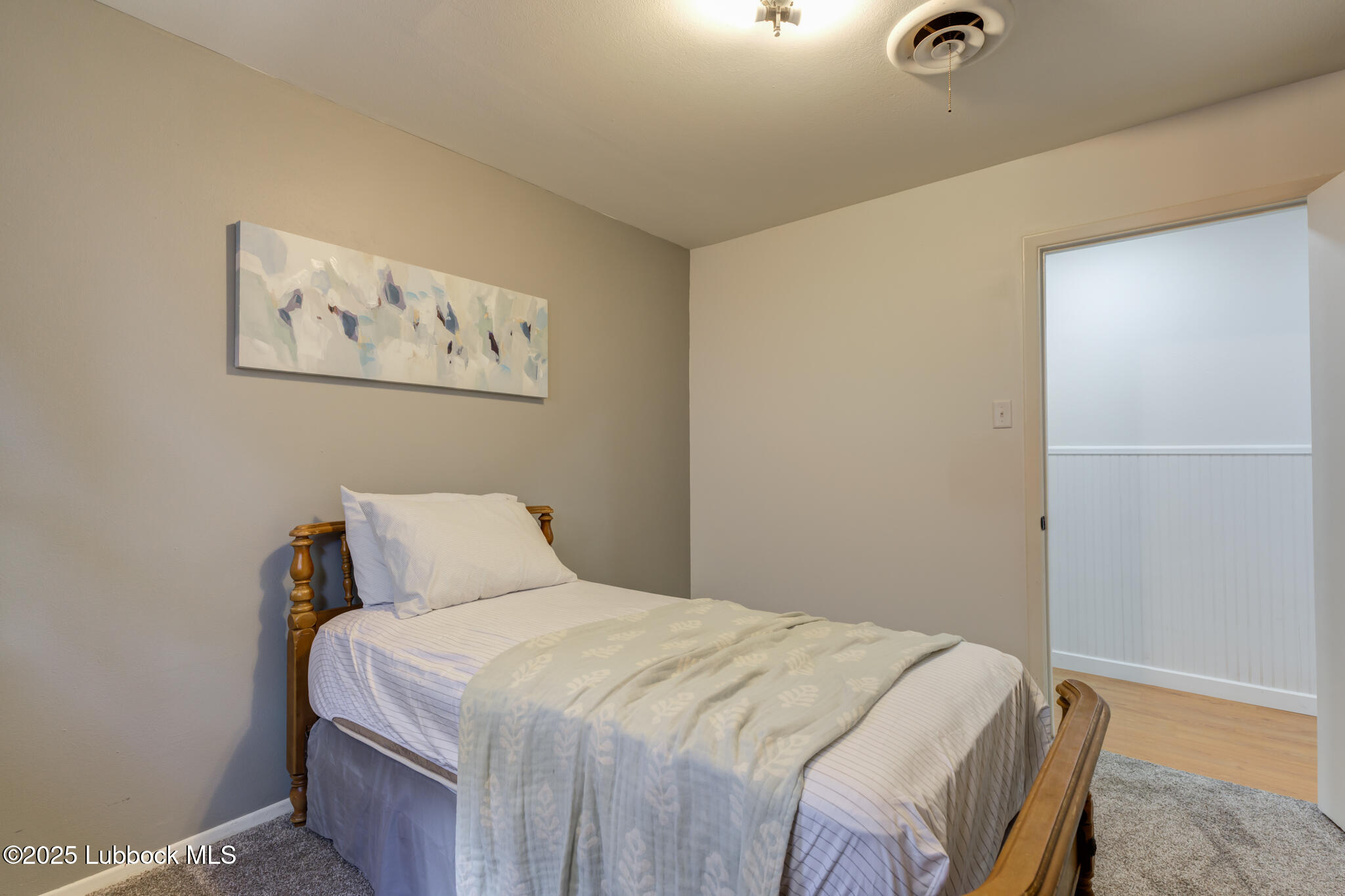 1205 Garland Plainview, TX 79072 - Photo 36 of 50 a bedroom with a bed and painting on the wall