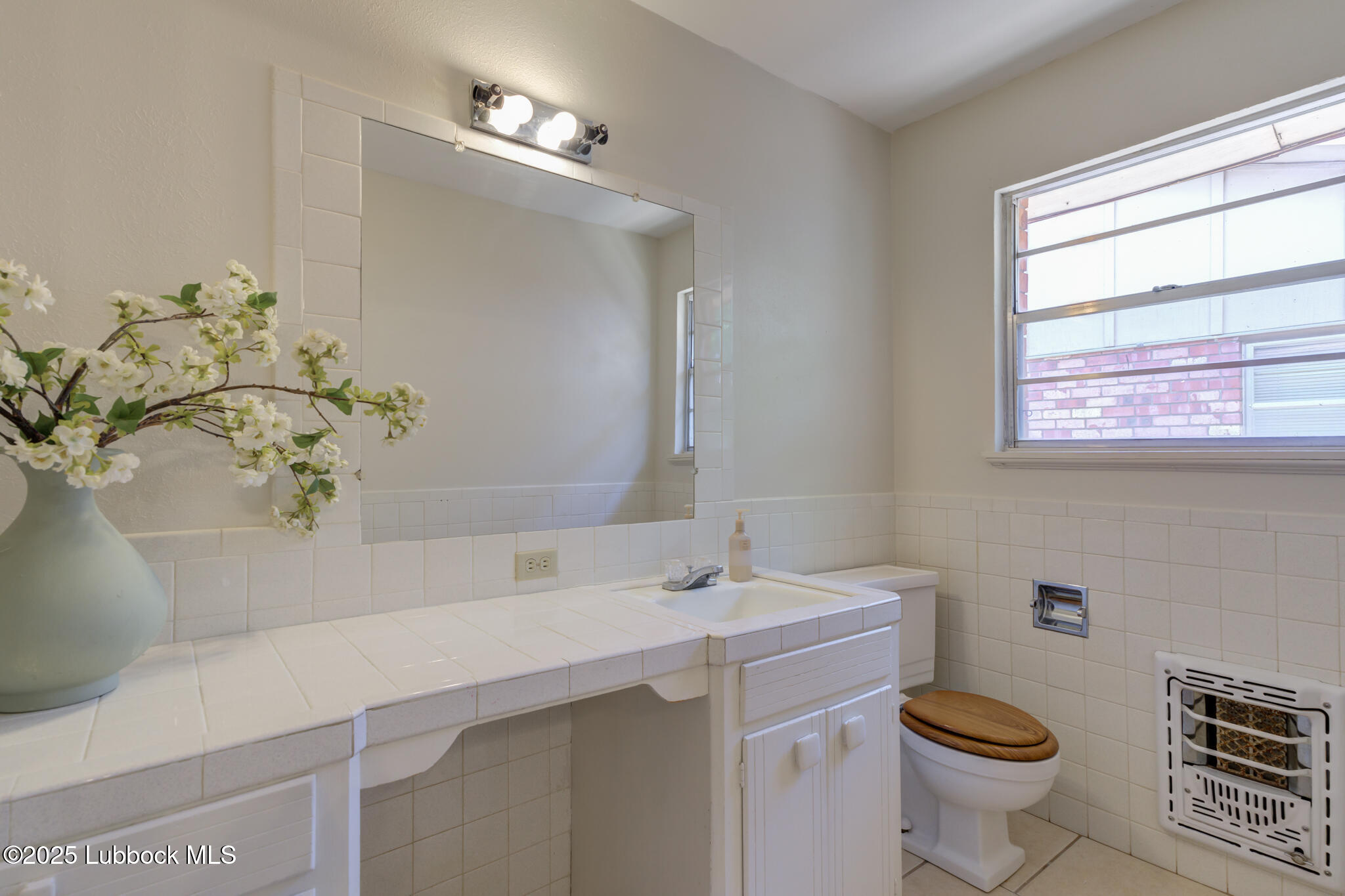1205 Garland Plainview, TX 79072 - Photo 39 of 50 a bathroom with a sink a toilet and a mirror
