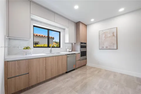 a kitchen with stainless steel appliances a sink and a stove top oven