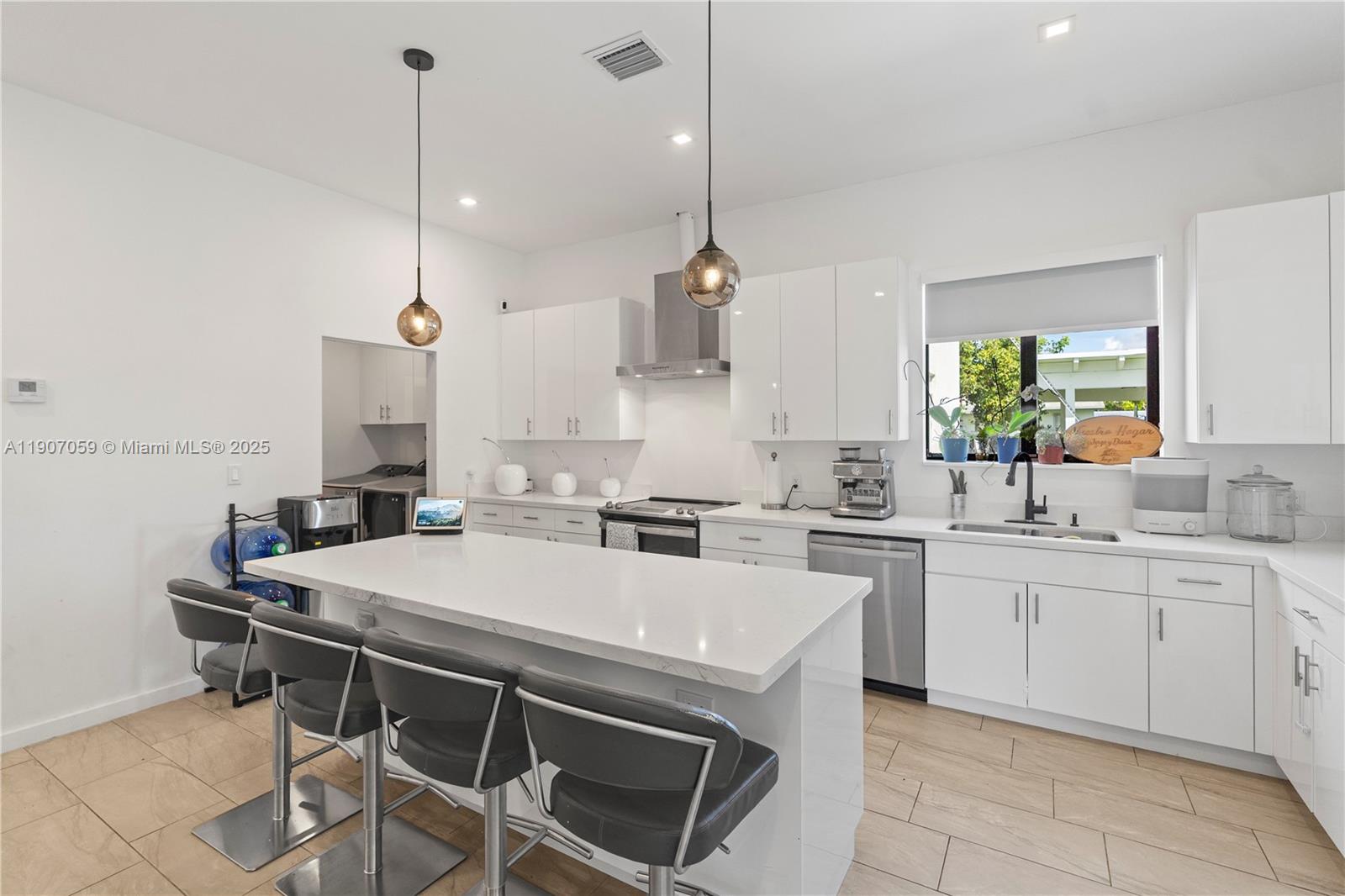 10925 Southwest 218th Terrace Miami, FL 33170 - Photo 15 of 32 a kitchen with a stove a sink a table and chairs
