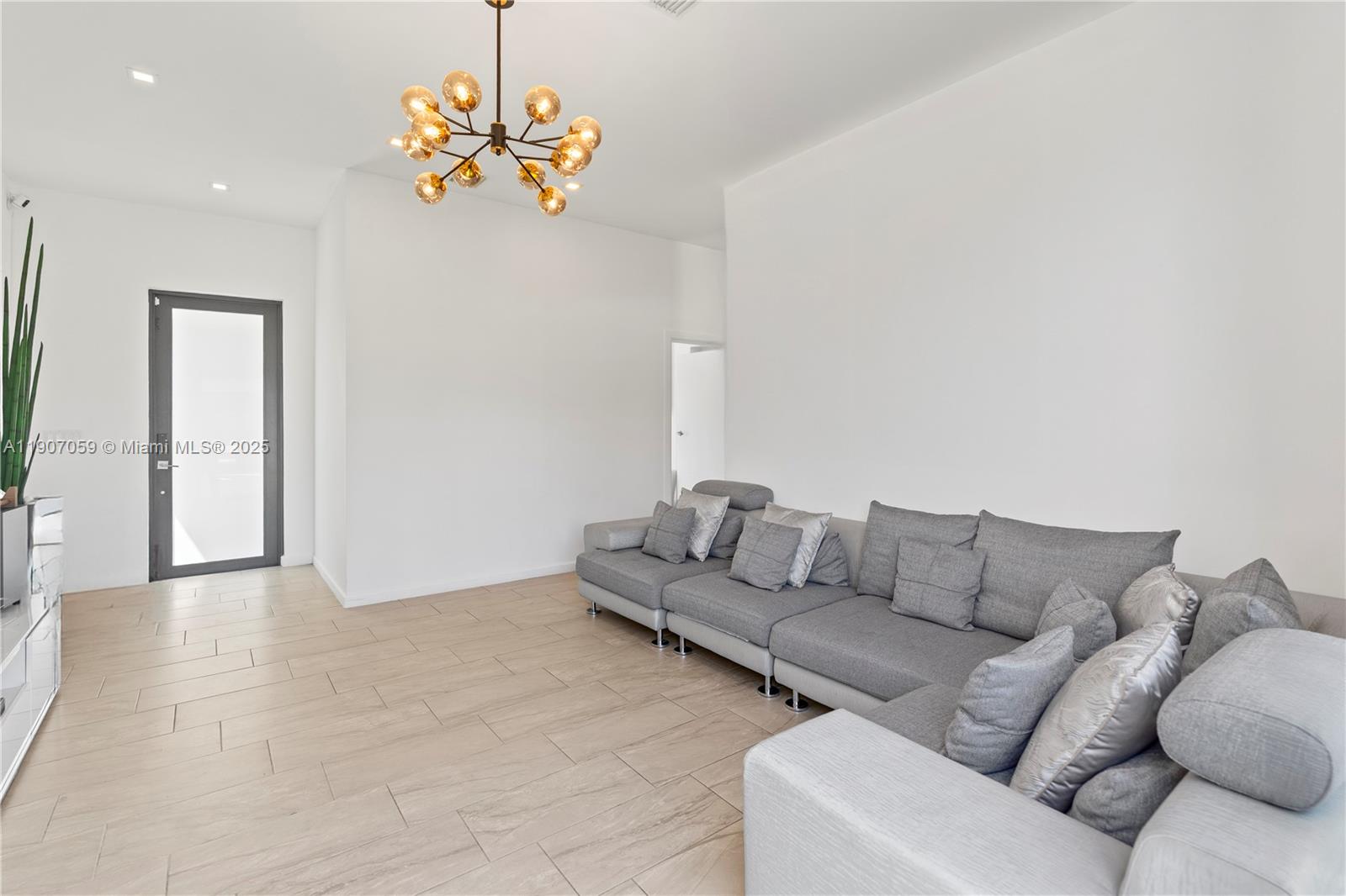 10925 Southwest 218th Terrace Miami, FL 33170 - Photo 23 of 32 a living room with furniture and a chandelier