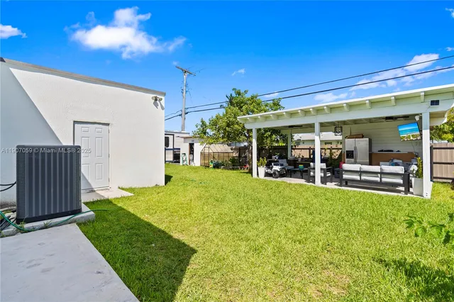 a living room with furniture and a pool table