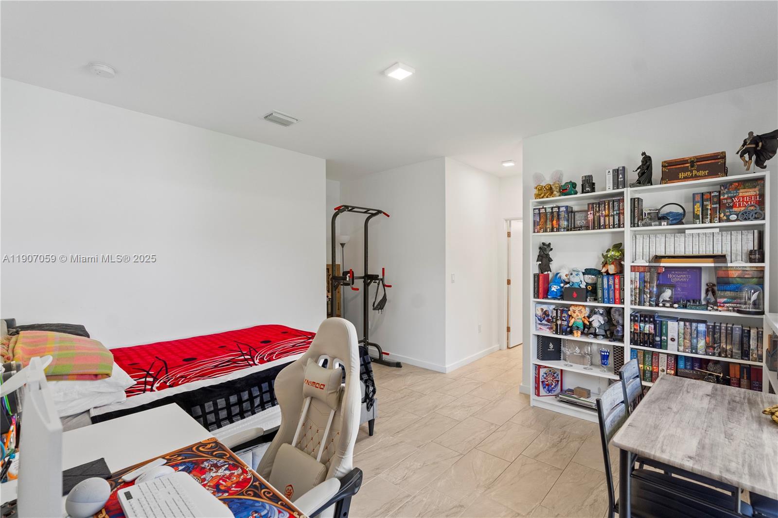 10925 Southwest 218th Terrace Miami, FL 33170 - Photo 30 of 32 a room with furniture toys and a book shelf