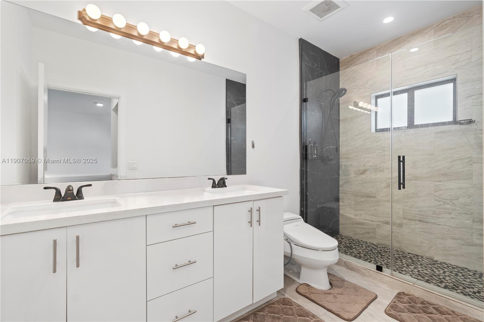 10925 Southwest 218th Terrace Miami, FL 33170 - Photo 32 of 32 a bathroom with a double vanity sink toilet and shower