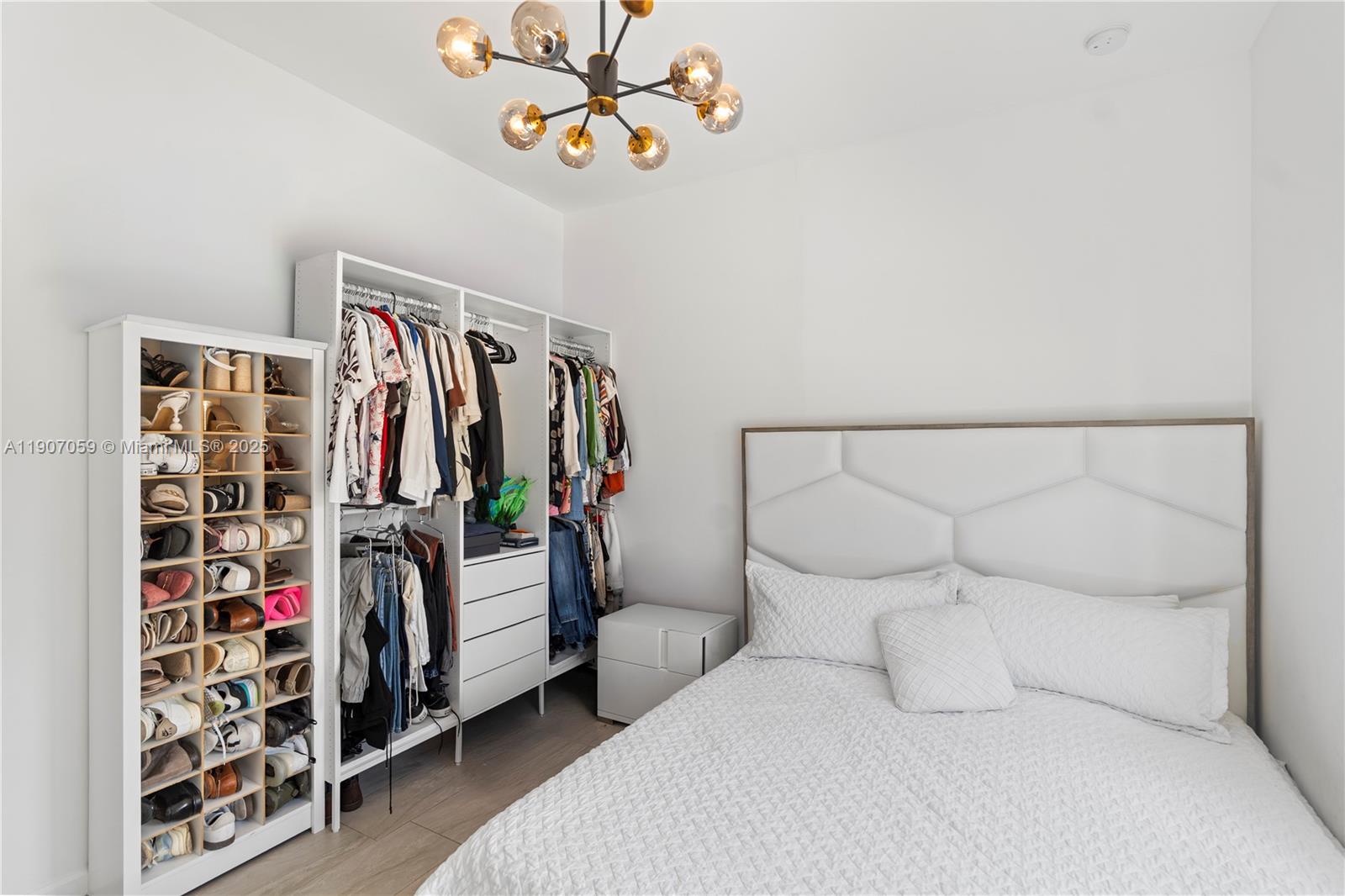 10925 Southwest 218th Terrace Miami, FL 33170 - Photo 8 of 32 a bedroom with a bed and a walk in closet