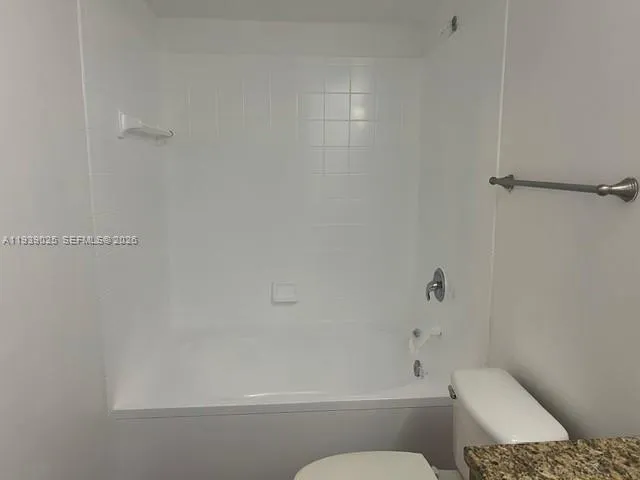 a bathroom with a toilet and shower