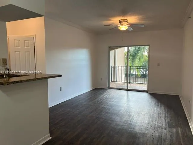 an empty room with wooden floor and a window