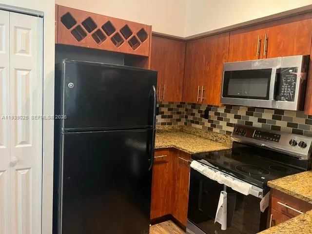 a kitchen with a stove microwave and refrigerator
