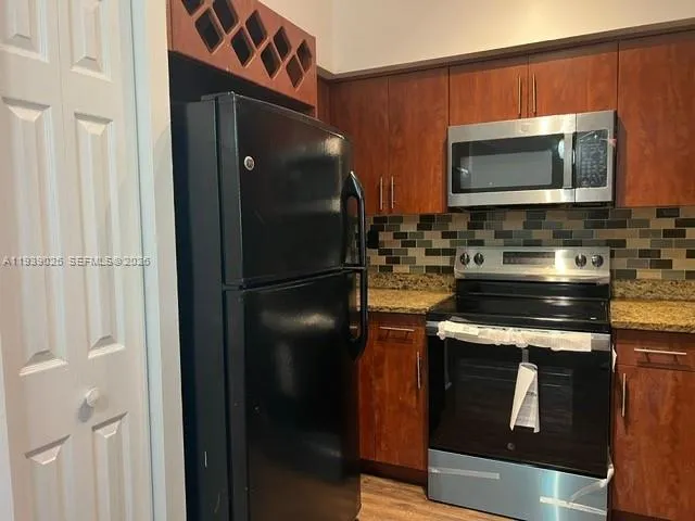 a kitchen with a refrigerator stove and microwave