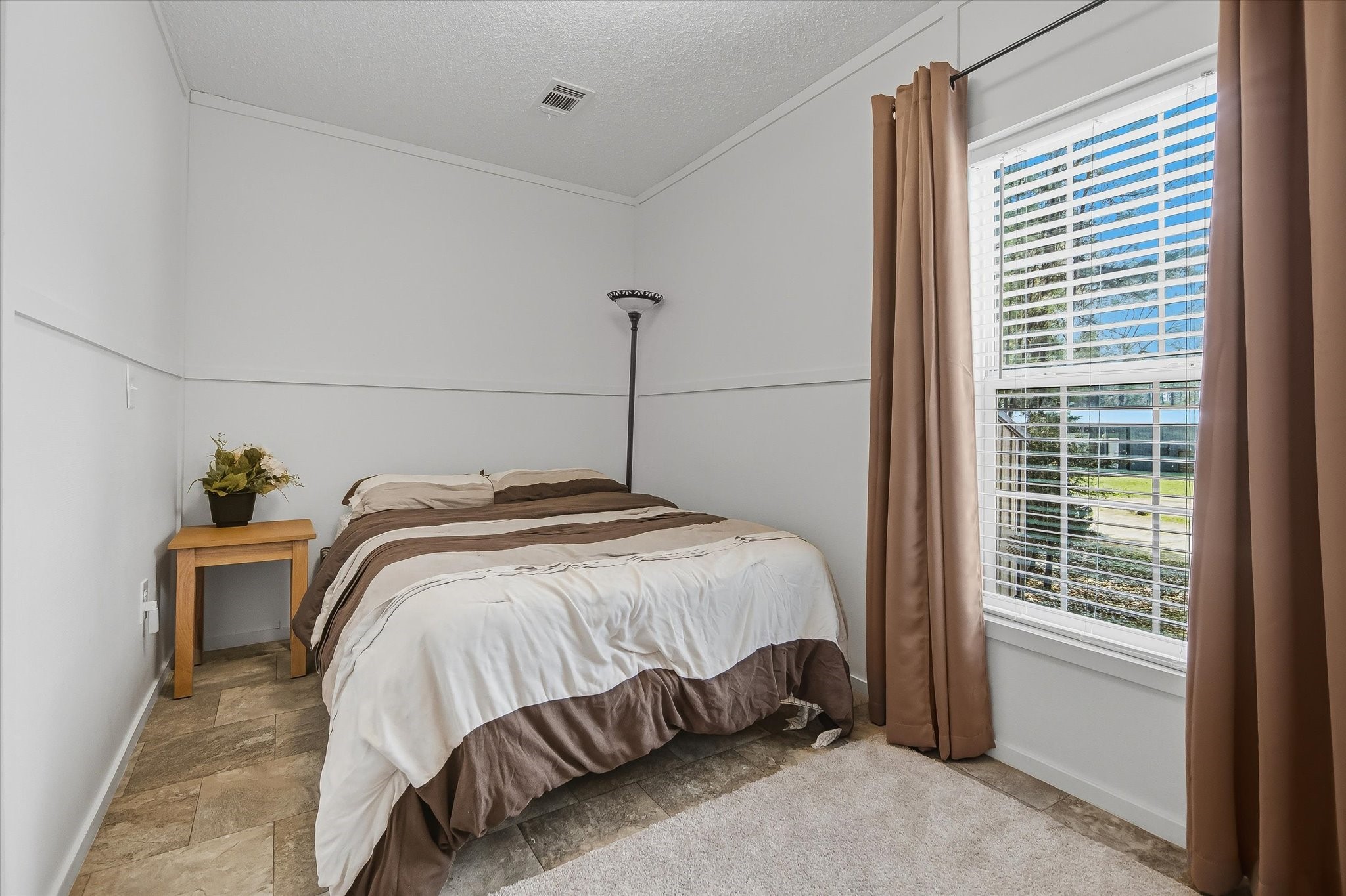 180 Elm Trail Trinity, TX 75862 - Photo 22 of 44 a bedroom with a bed and a window