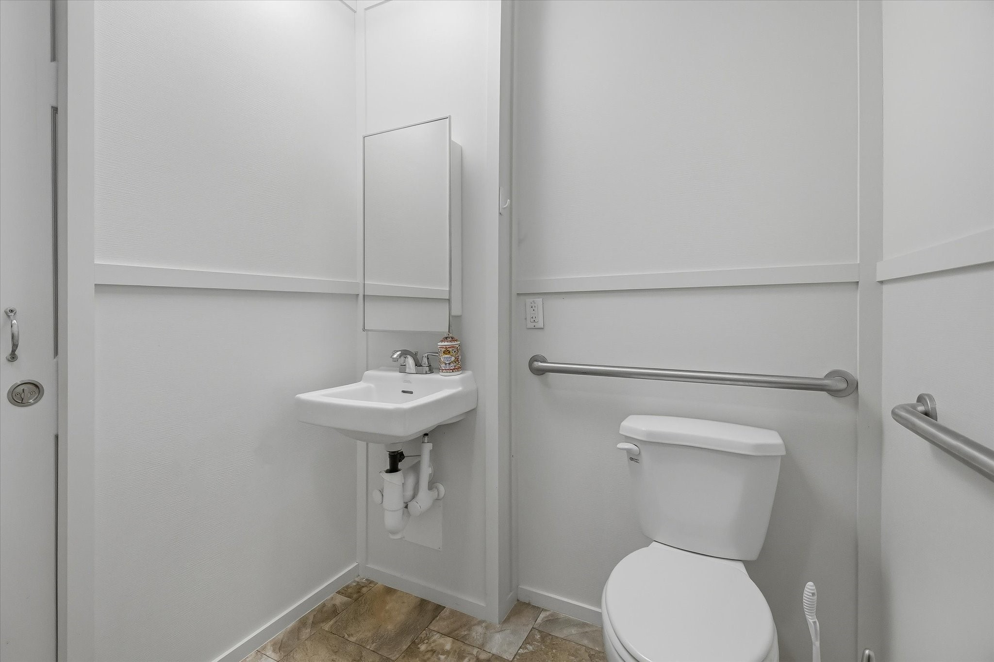 180 Elm Trail Trinity, TX 75862 - Photo 25 of 44 a bathroom with a sink toilet and a mirror