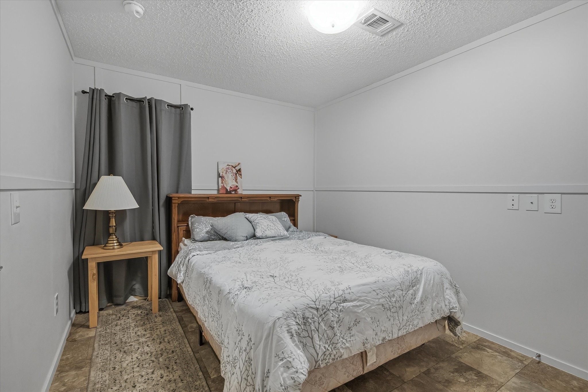 180 Elm Trail Trinity, TX 75862 - Photo 28 of 44 a bedroom with a bed and a chair