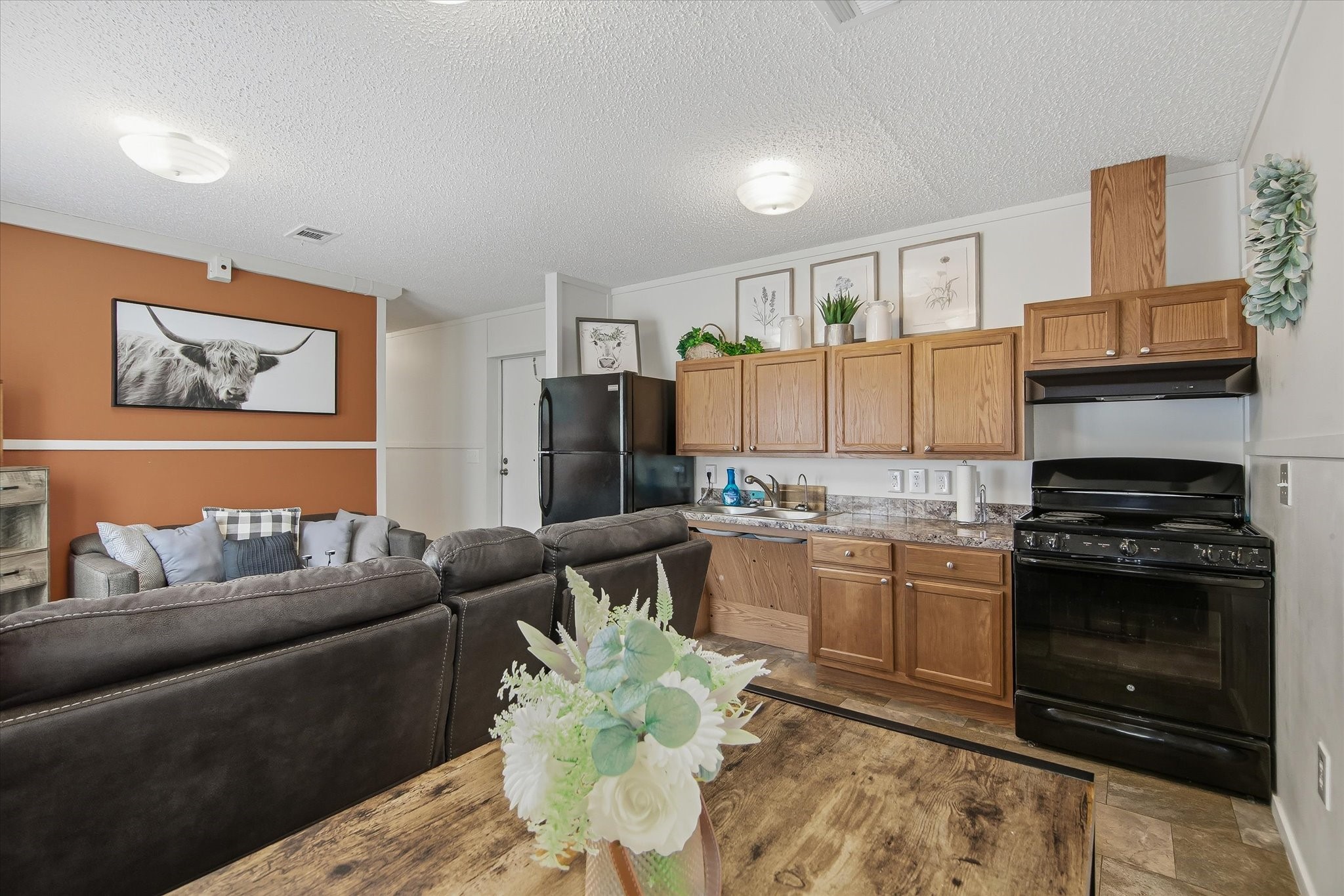 180 Elm Trail Trinity, TX 75862 - Photo 7 of 44 a living room with stainless steel appliances kitchen island granite countertop a stove a sink and a microwave