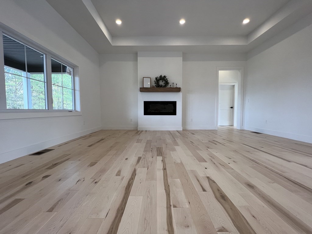 47 Stratton Farms Road Suffield, CT 06093 - Photo 12 of 28 an empty room with wooden floor windows and ceiling fan
