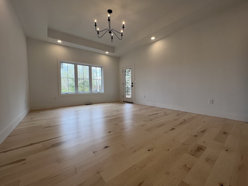47 Stratton Farms Road Suffield, CT 06093 - Photo 19 of 28 an empty room with wooden floor and windows