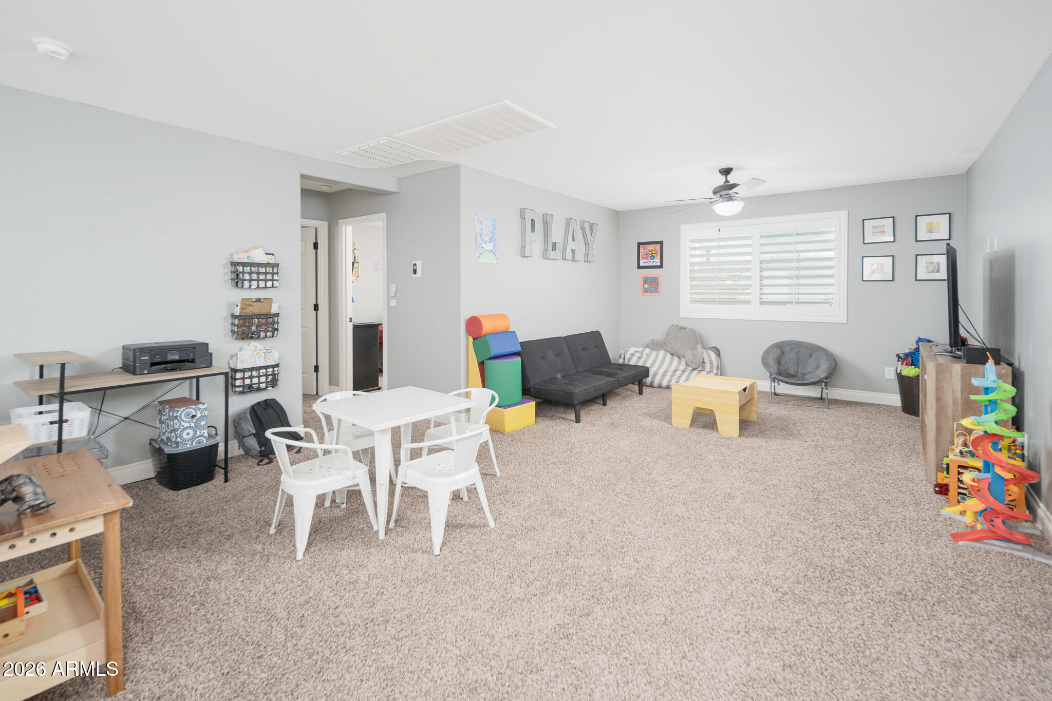 10789 West Yearling Road Peoria, AZ 85383 - Photo 13 of 35 a living room with furniture and a flat screen tv