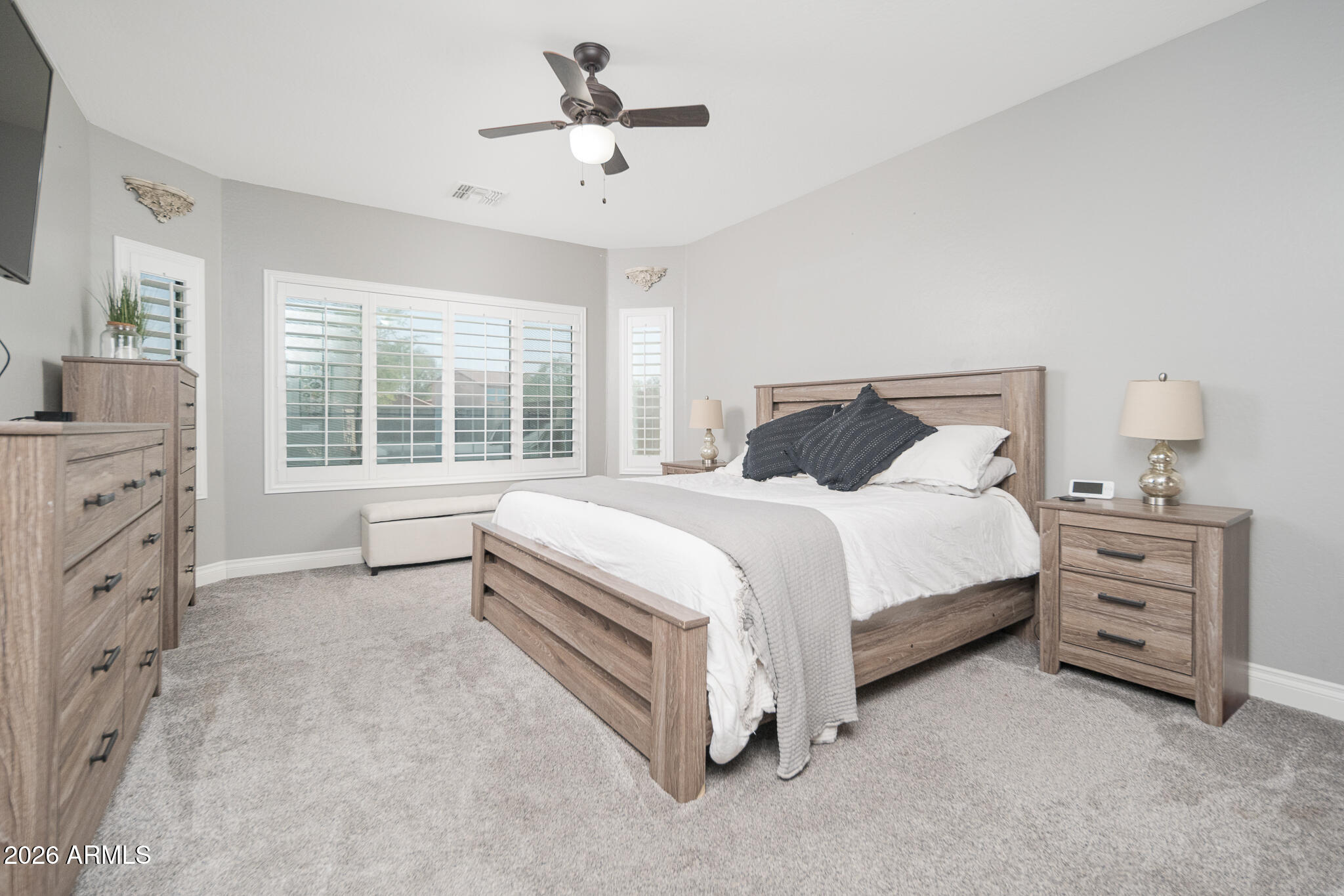 10789 West Yearling Road Peoria, AZ 85383 - Photo 17 of 35 a bedroom with a bed dresser and a window