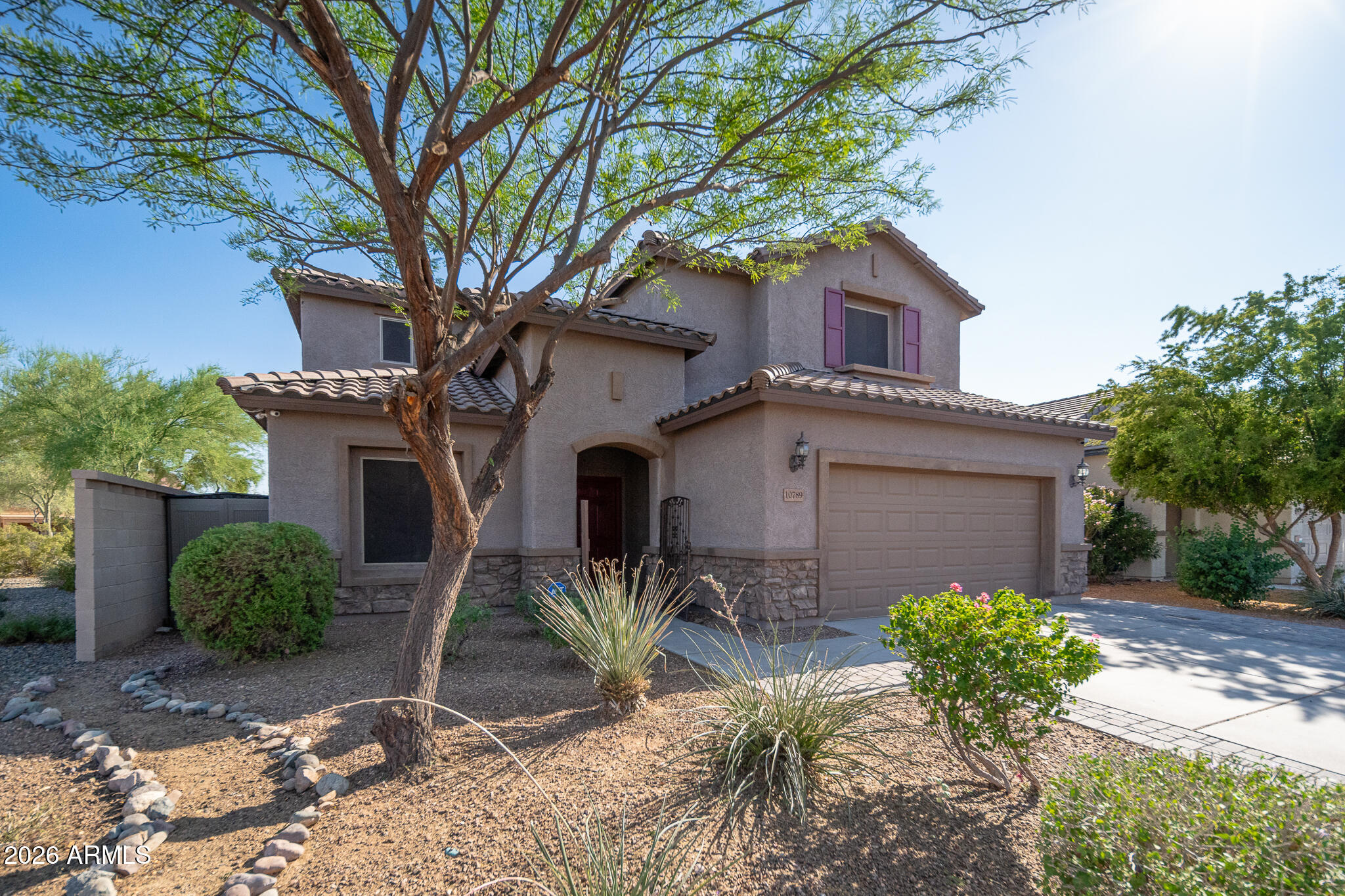 10789 West Yearling Road Peoria, AZ 85383 - Photo 2 of 35 a front view of a house with garden