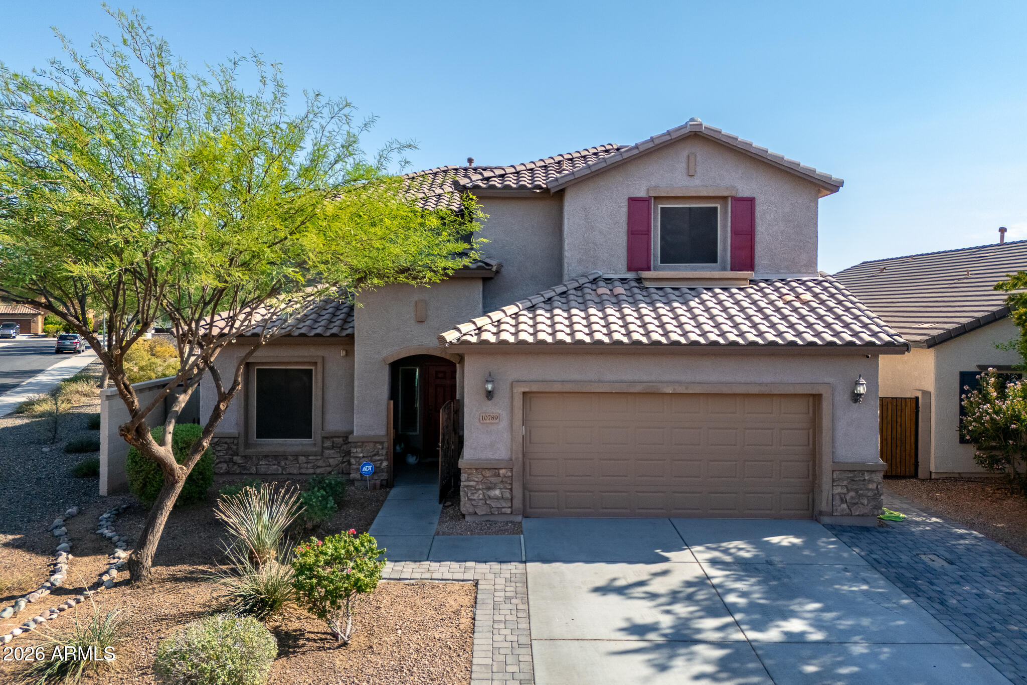 10789 West Yearling Road Peoria, AZ 85383 - Photo 26 of 35 a front view of a house with a garden