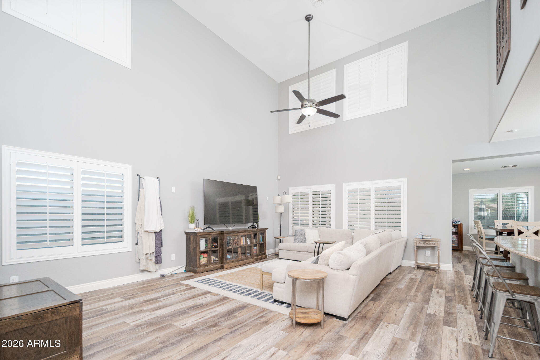10789 West Yearling Road Peoria, AZ 85383 - Photo 3 of 35 a living room with furniture a window and a flat screen tv