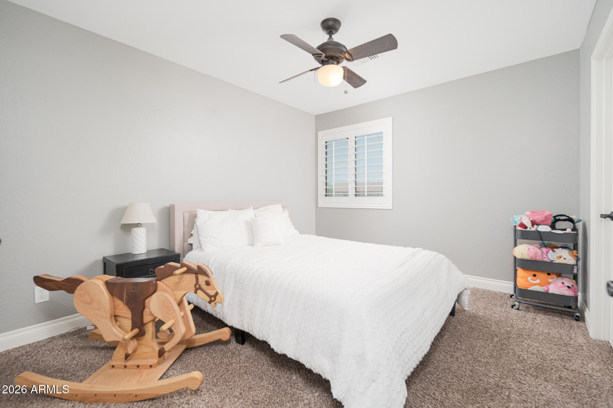 10789 West Yearling Road Peoria, AZ 85383 - Photo 8 of 35 a bedroom with a bed and a chandelier
