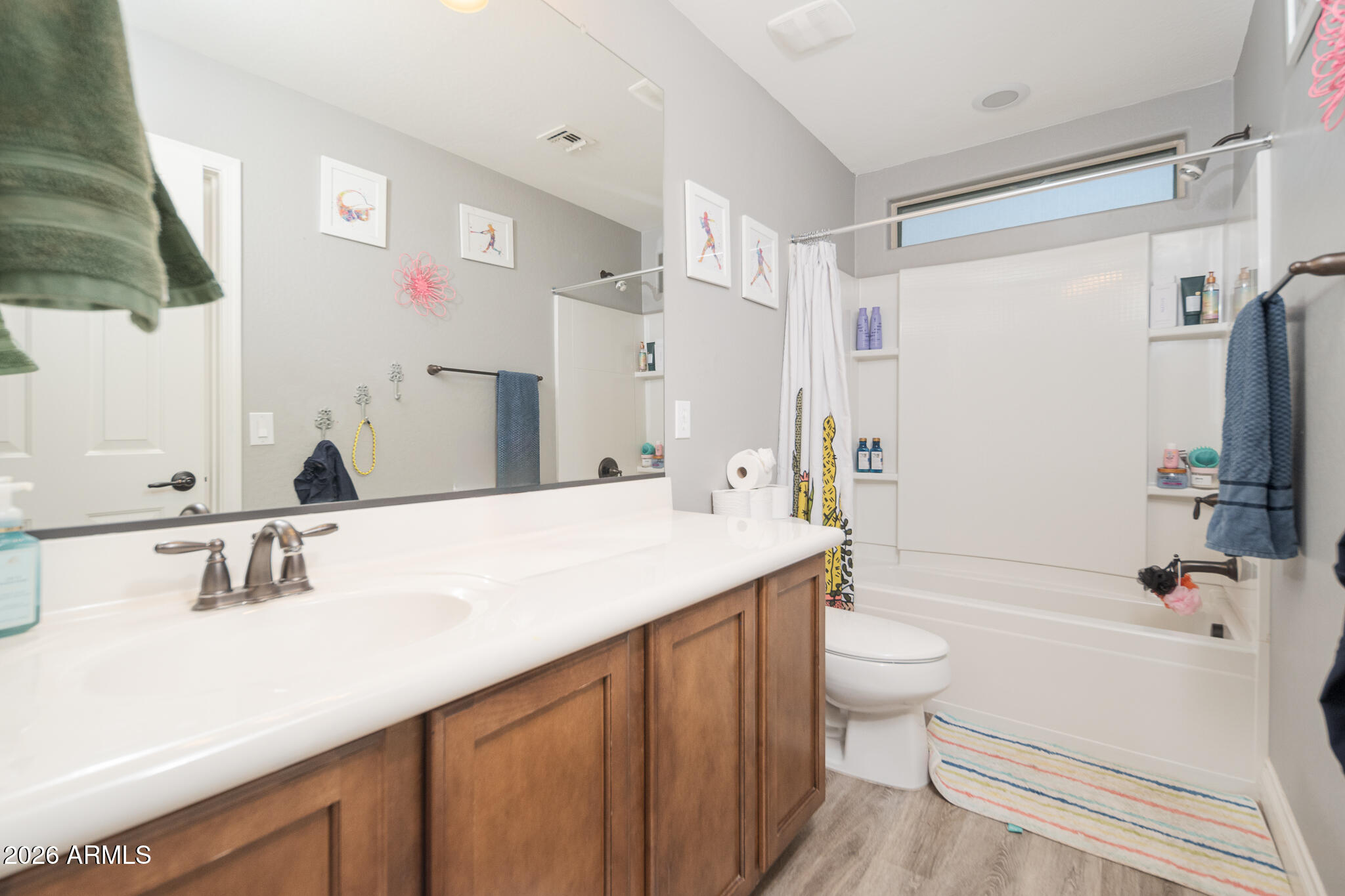 10789 West Yearling Road Peoria, AZ 85383 - Photo 9 of 35 a bathroom with a sink a toilet a mirror and shower