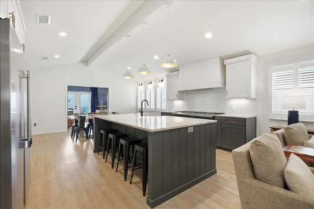 a kitchen with counter top space a sink stainless steel appliances
