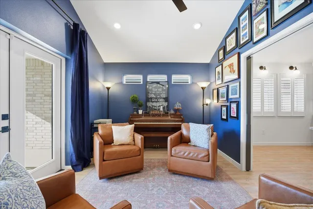 a bedroom with a bed a couch and a chandelier