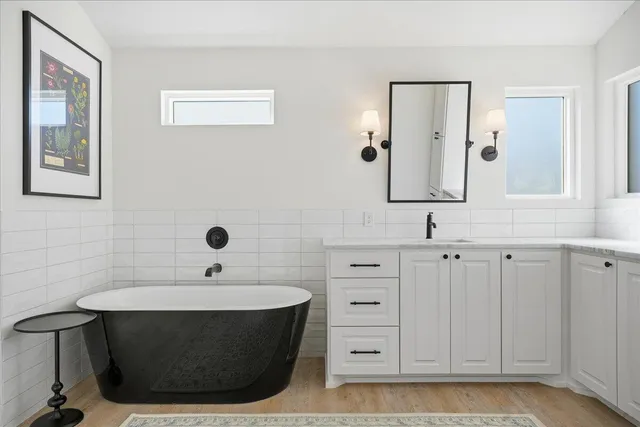 a view of a hallway with closet and wooden floor