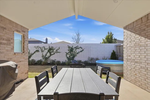 a view of a pathway of a house with wooden fence