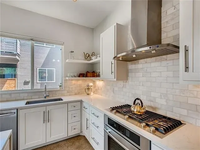 a kitchen with a stove and a sink