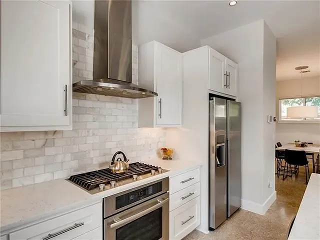 a stove top oven sitting inside of a kitchen