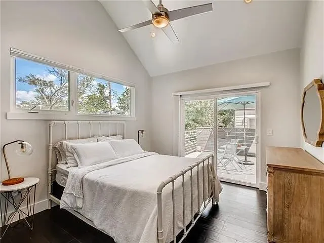 a bedroom with a bed a window and a chandelier
