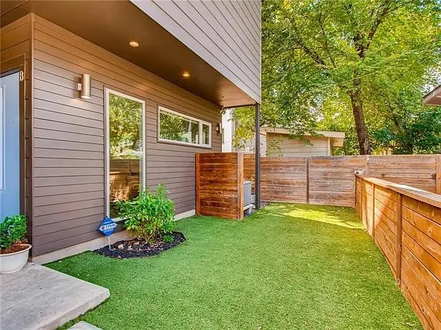 a view of a chair and table in backyard of the house