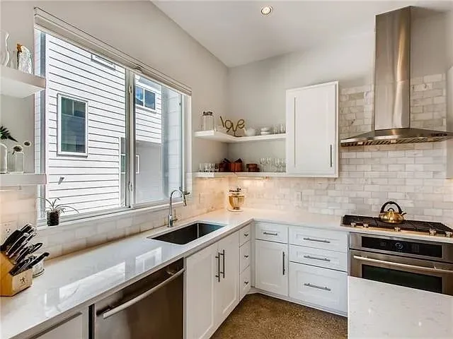 a kitchen with a sink stove and cabinets