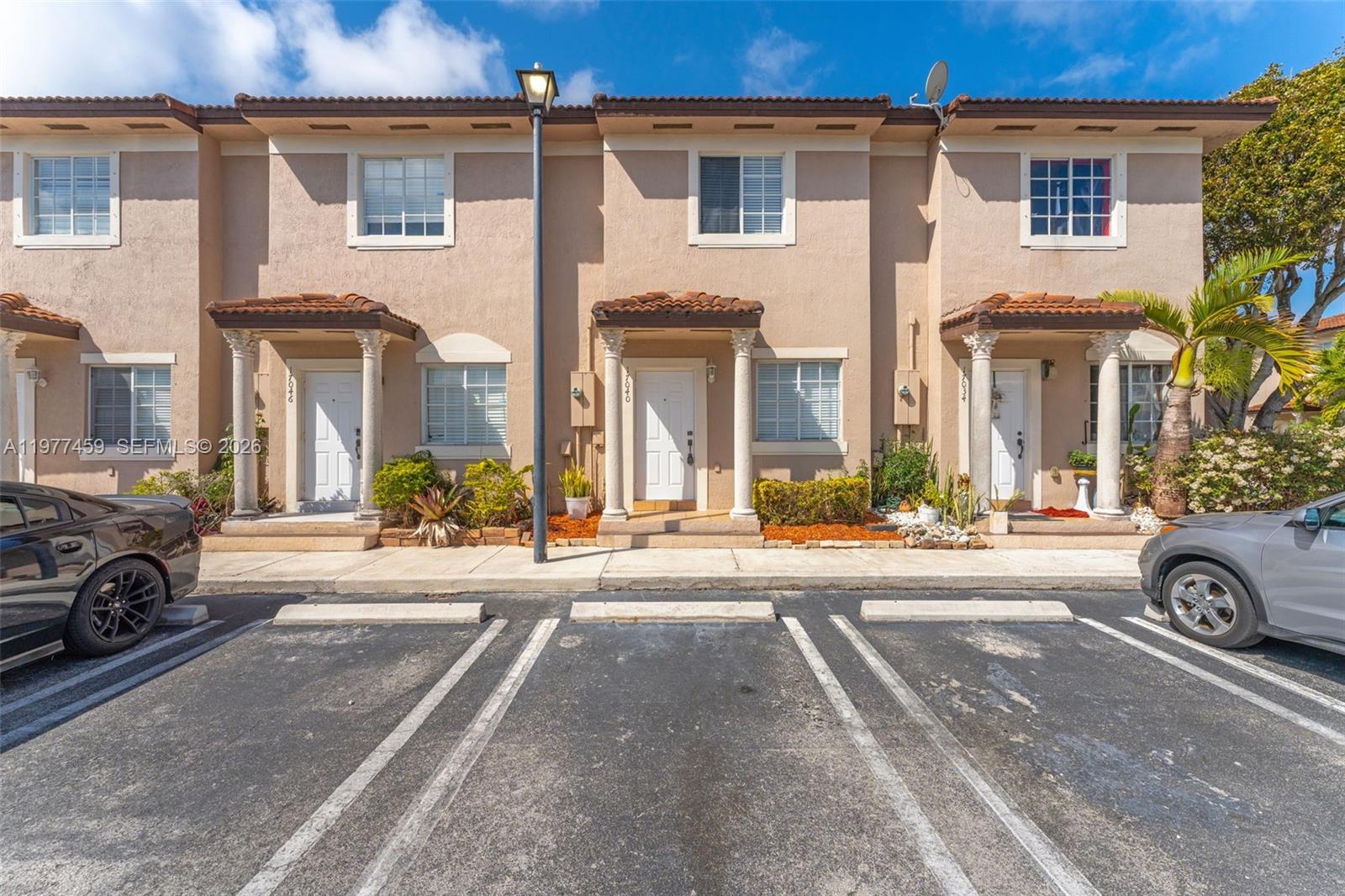 17040 Southwest 137th Place Miami, FL 33177 - Photo 1 of 29 front view of a house with a cars park front of a house
