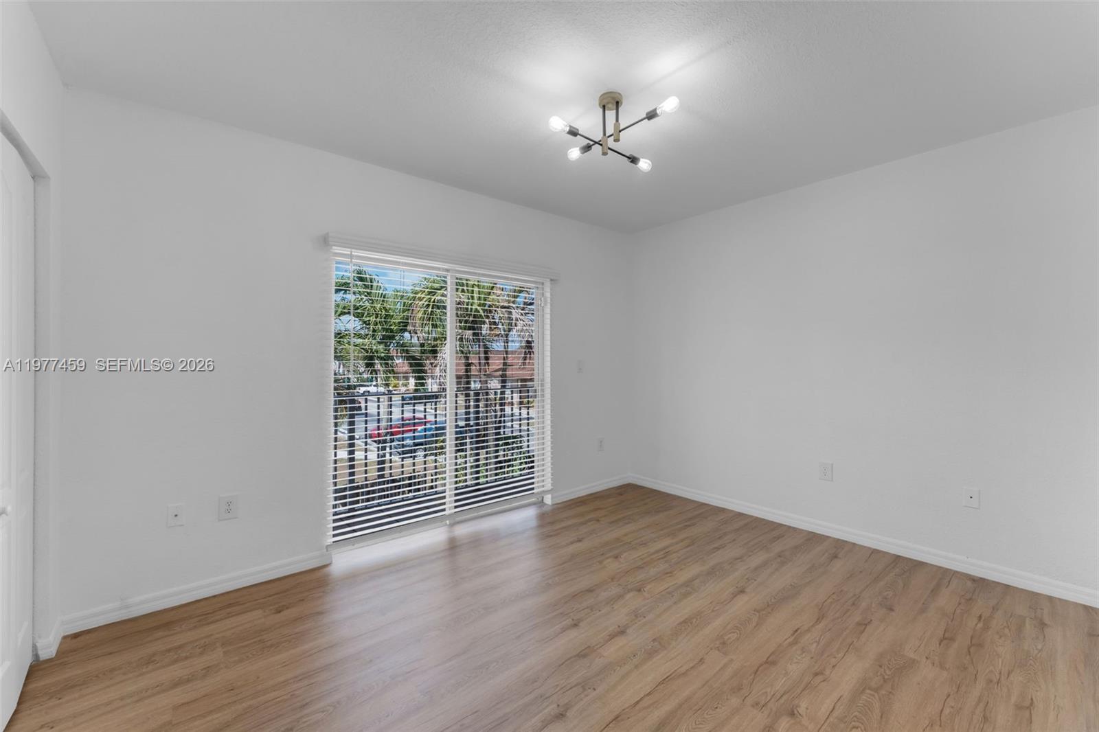17040 Southwest 137th Place Miami, FL 33177 - Photo 13 of 29 wooden floor in an empty room with a window