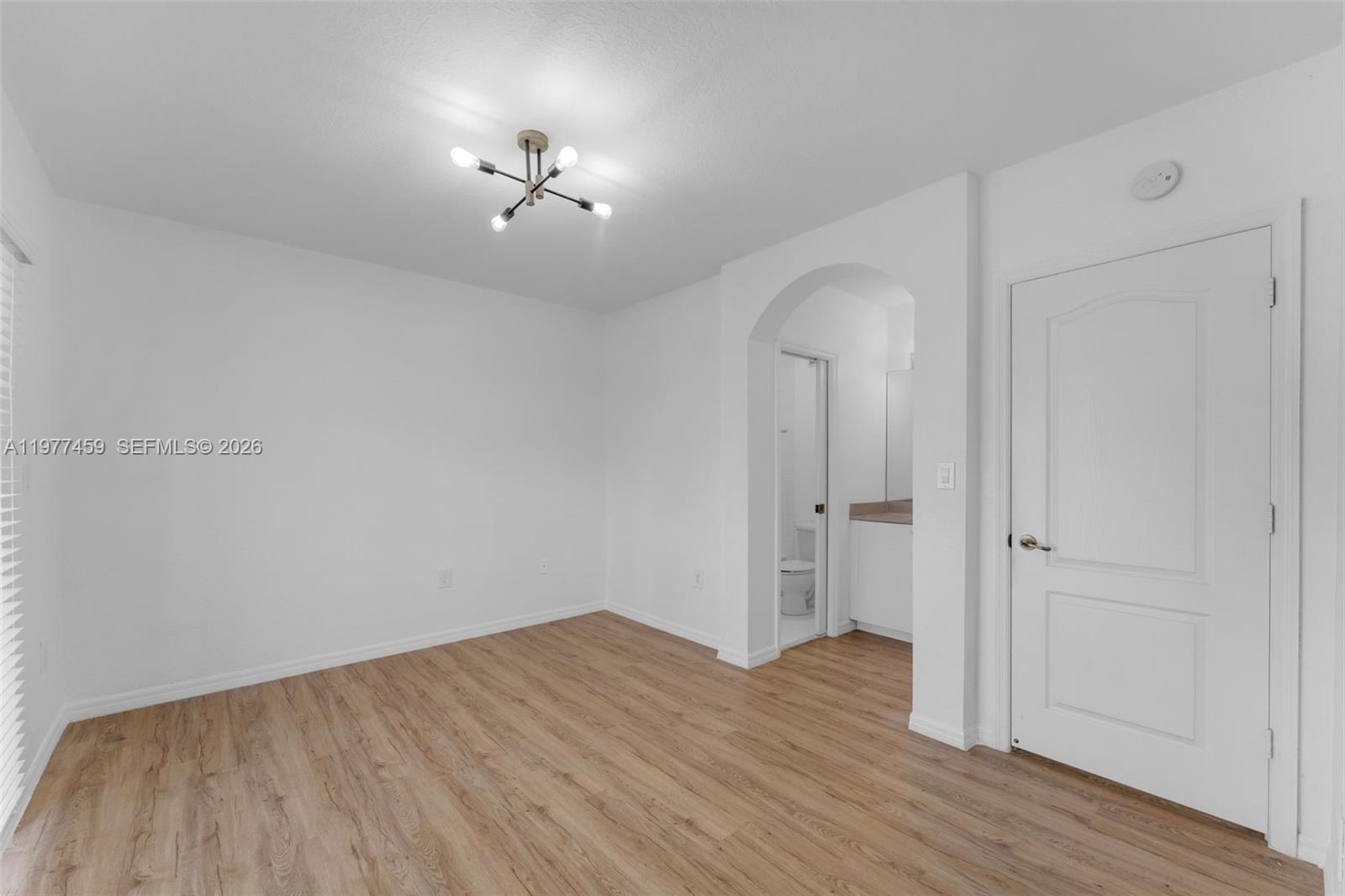 17040 Southwest 137th Place Miami, FL 33177 - Photo 14 of 29 wooden floor in an empty room with a window