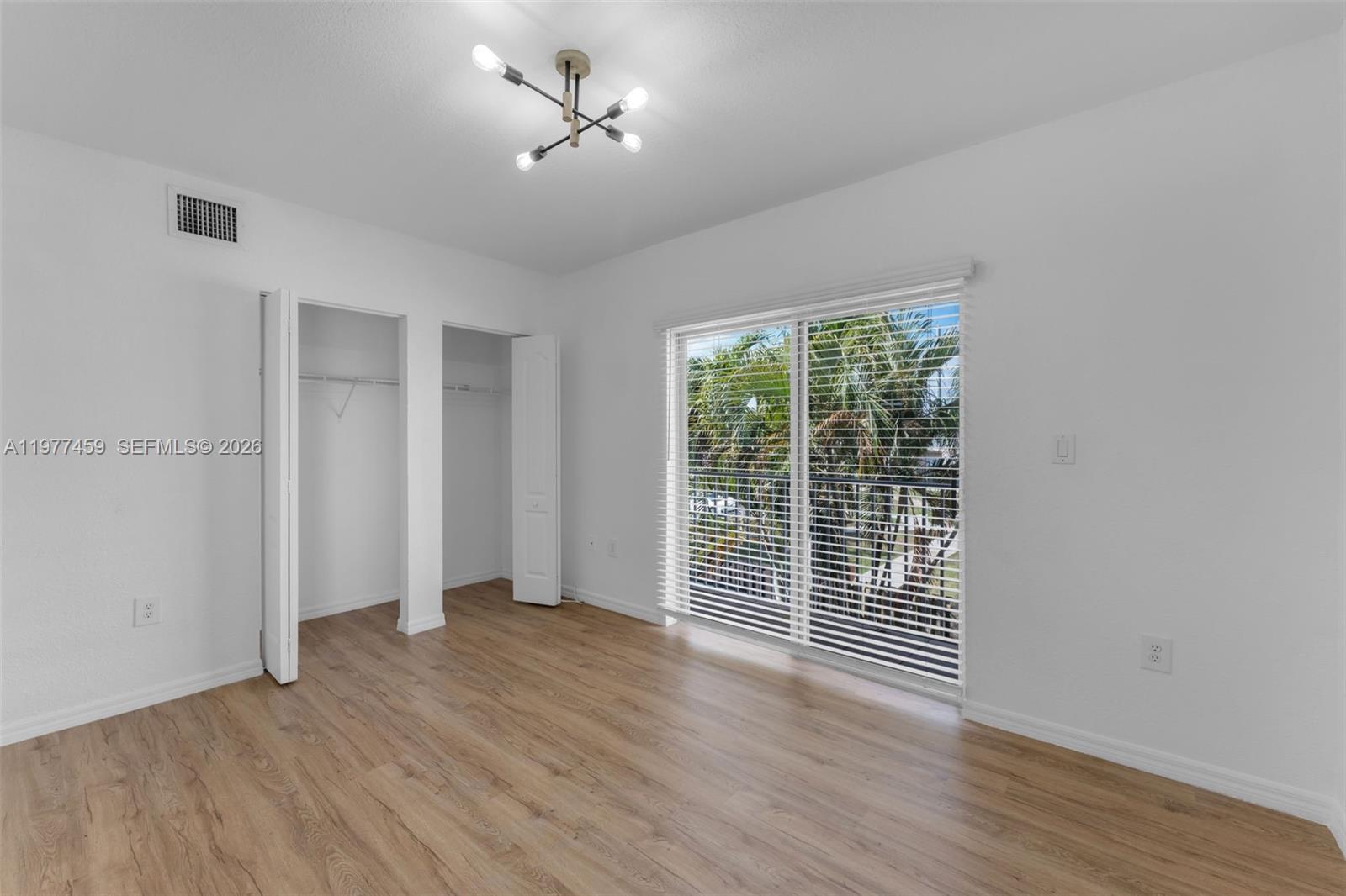 17040 Southwest 137th Place Miami, FL 33177 - Photo 15 of 29 a view of a room with wooden floor and ceiling fan