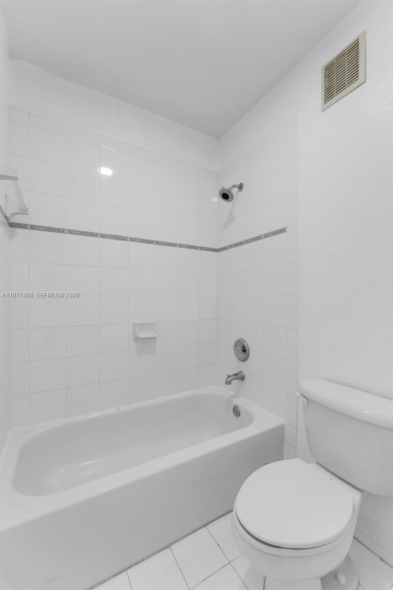 17040 Southwest 137th Place Miami, FL 33177 - Photo 18 of 29 a bathroom with a toilet and a bathtub