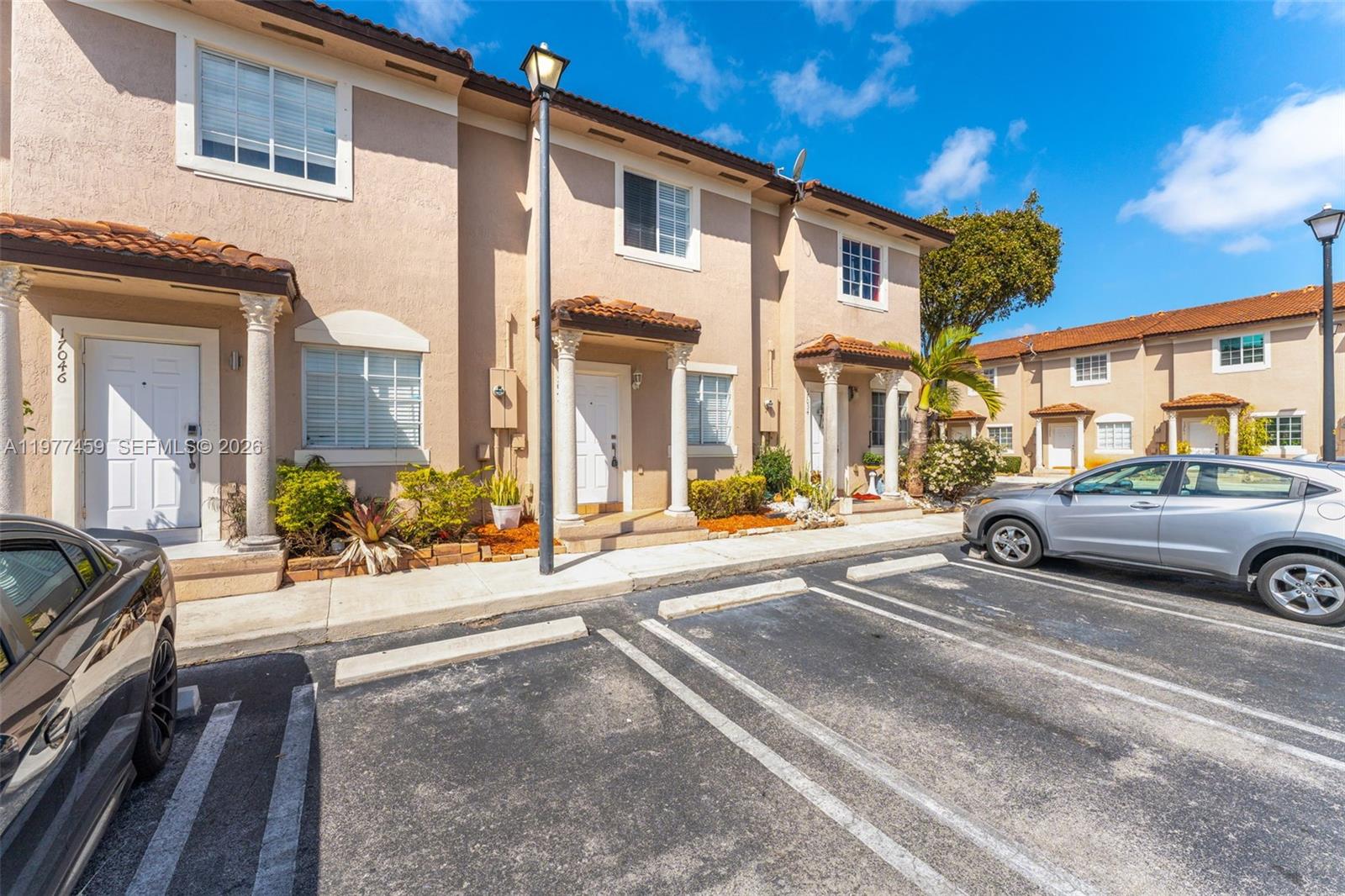 17040 Southwest 137th Place Miami, FL 33177 - Photo 2 of 29 a view of a car park in front of a building