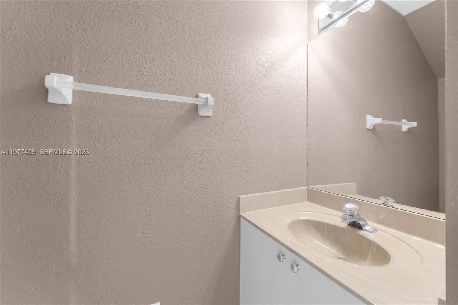 17040 Southwest 137th Place Miami, FL 33177 - Photo 21 of 29 a bathroom with a sink and mirror