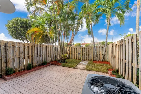 a view of a backyard with iron fence
